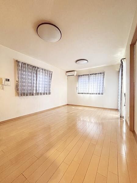 【一部AIモノ消し済み・実際の室内状況優先】明るい色合いのフローリングが室内全体に開放感を与えています。大きな窓から自然光がしっかり差し込みリビング空間が広々と感じられます。
