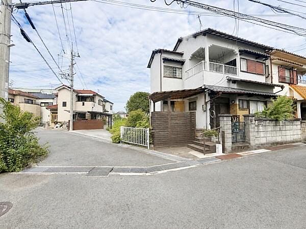 【一部AIモノ消し済み・実際の状況優先】角地に位置し開放感のある建物です。道幅が広めで車の出し入れもしやすい環境です。周囲は住宅が多く落ち着いた雰囲気が感じられます。