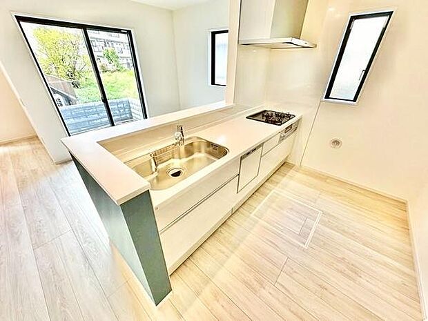 キッチンは窓から明るい自然光が差し込む開放的な空間です。ワイドな作業スペースが確保されお手入れのしやすいシンプルなデザインが特徴的です。収納やシンクまわりも考えられた設計です。