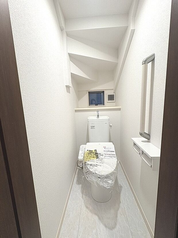 階段下を有効活用したトイレスペース。 便座はもちろんウォシュレット。  