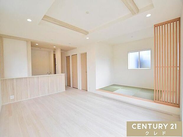 【LDK19.5帖】白と木目を基調としたナチュラルテイストの空間。折上天井が開放感を演出します。リビング横には小上がりの畳コーナーを完備し、ご家族でゆったりくつろげる憩いの空間です。