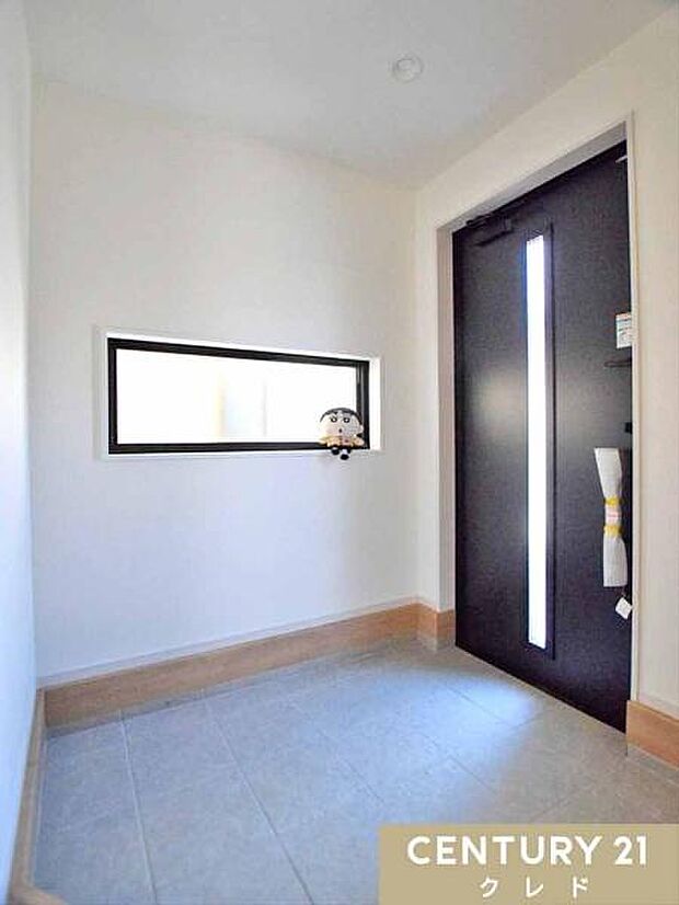 横長窓から柔らかな光が差し込む、明るく広々とした玄関。靴の脱ぎ履きや荷物の置き場としても使いやすい、機能的な設計です。