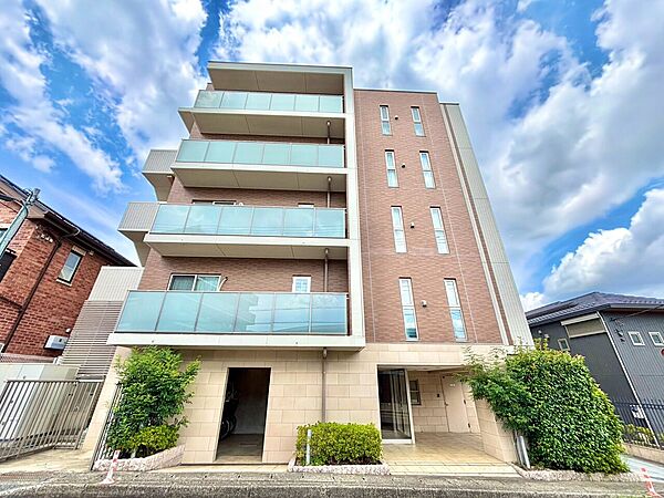 バルコニー付きの低層マンションの外観写真です