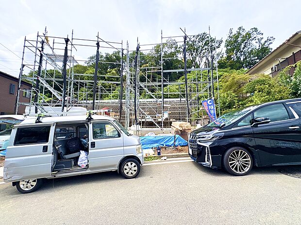 建設中の住宅現場と駐車中の車の様子