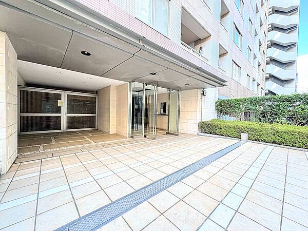 タイル張りのマンションエントランス外観と歩道