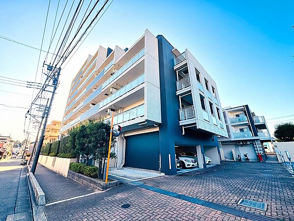 複数階の大型マンション外観、周辺に電柱と歩道あり