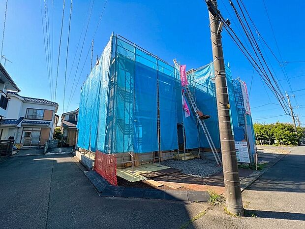 青い外壁の建築物を道路側から見た外観