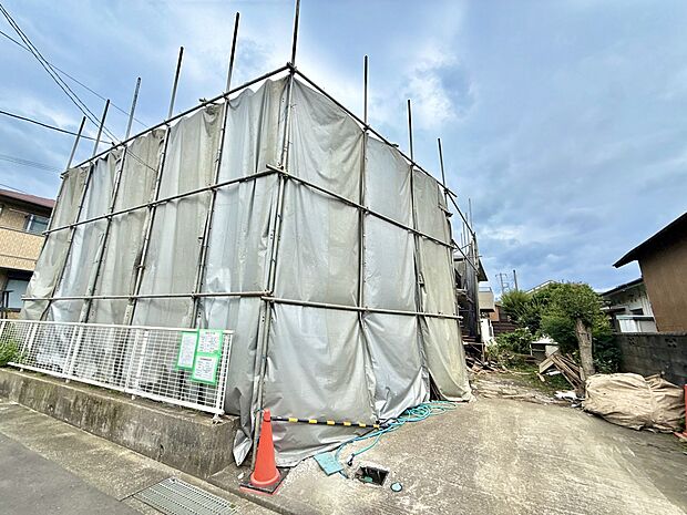 建築中の建物を覆う足場と養生シート