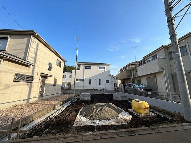 建築中の住宅と周辺の建物が見える街並み