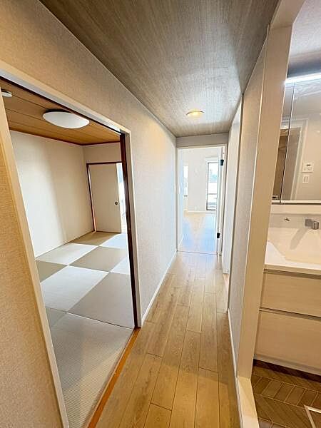 玄関から廊下まで明るい光が差し込み清潔感のある空間になっています。シンプルなデザインで幅広いインテリアにも調和します。和室とのアクセスも良好で日常の動線がスムーズです。