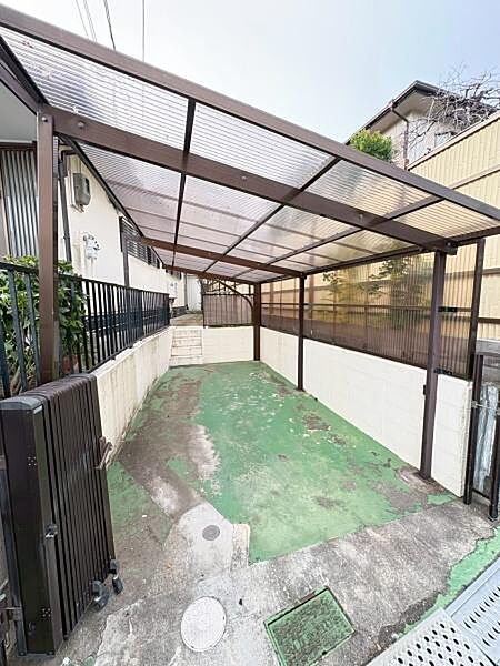 屋根付きの駐車スペースが用意されています。両側の壁で周囲からの視線が気になりにくい造りです。ゲート付きでセキュリティ面にも配慮されています。敷地内にゆとりのあるレイアウトです。