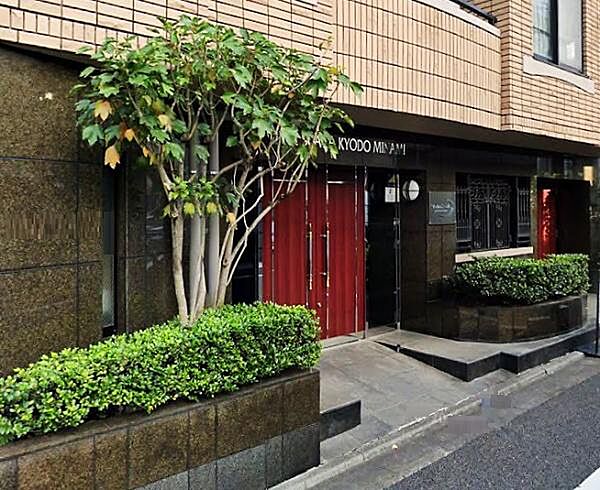 大理石貼りの高級感あるエントランス。モダンな赤色の扉が人目を引きます。