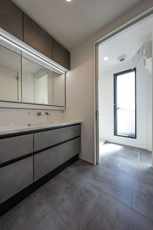 高級感漂うワイドな洗面化粧台。三面鏡裏の収納やゆとりある足元スペースで、忙しい朝の身支度もスムーズに整います。