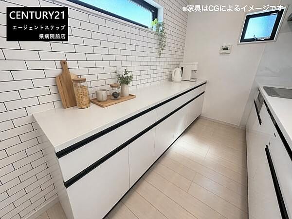 シンプルなデザインのキッチンが印象的です。収納スペースが充実しており日々の整理整頓に役立ちます。壁面のタイルが清潔感を演出しています。小窓から自然光が入り明るさを確保できる空間です。