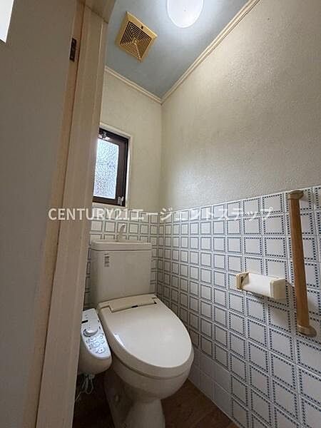 小窓が設けられているため自然光が入りやすいトイレです。温水洗浄便座が備わっています。手すりもあり立ち座りがしやすい設計になっています。壁のデザインは落ち着いた雰囲気です。