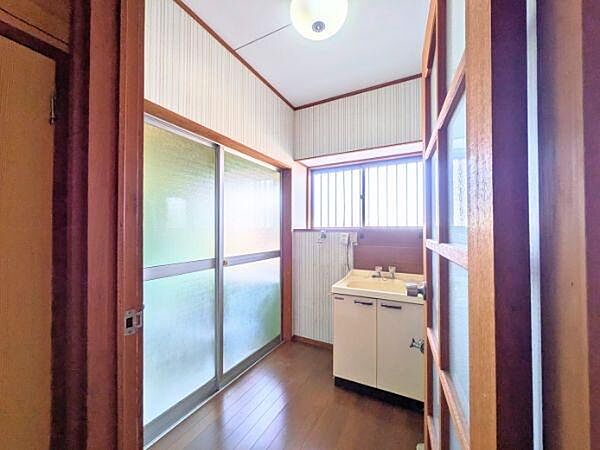 明るい光が差し込む洗面所は毎日心地よく使えます。窓付きで換気もしやすく清潔感を保ちやすい空間です。木目調の仕上げが落ち着いた雰囲気を演出しています。