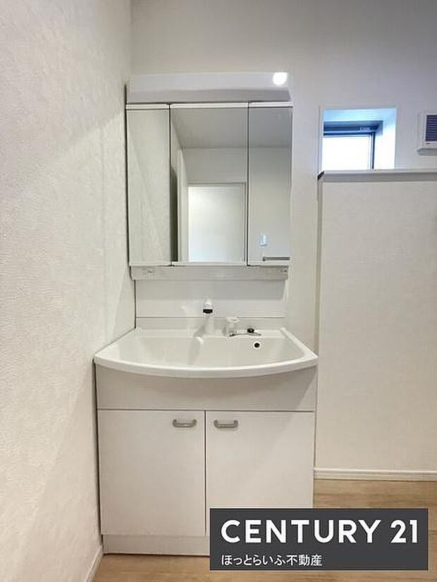 シンプルなデザインの洗面台が空間にすっきりと馴染みます。収納付きで実用性にも優れています。鏡が広く全体の明るさを感じられます。窓が設けられた洗面所は換気もしやすい仕様です。