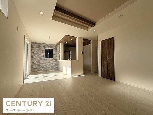 リビングは開放感のある空間です。窓からの自然光がしっかりと差し込み明るさを感じられます。天井の木目調デザインがアクセントになっております。床や壁の色合いがやわらかい印象を演出し落ち着いた雰囲気です。