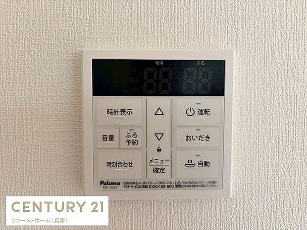 壁面に設置されたシンプルなデザインの給湯リモコンです。各種操作ボタンが分かりやすく配置され視認性に優れています。操作パネルは直感的に使いやすい仕様です。清潔感のあるホワイトカラーが特徴です。