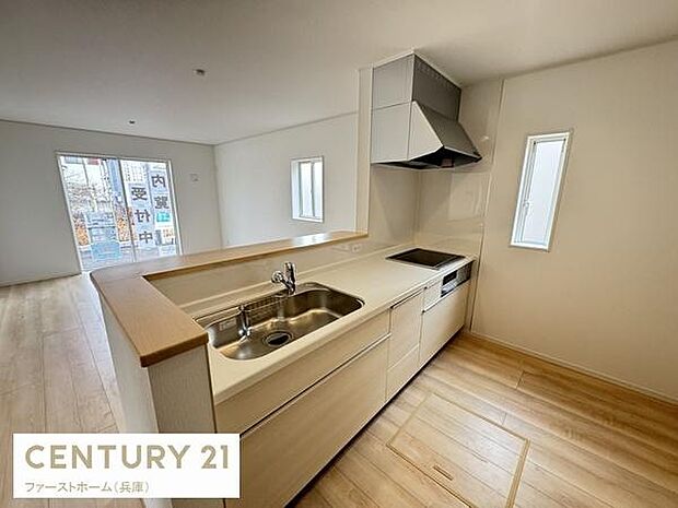 明るく開放感のあるキッチンです。清潔感のあるデザインが印象的です。カウンター付きで効率的なスペースになっています。収納も充実しています。窓から自然光が入ります。