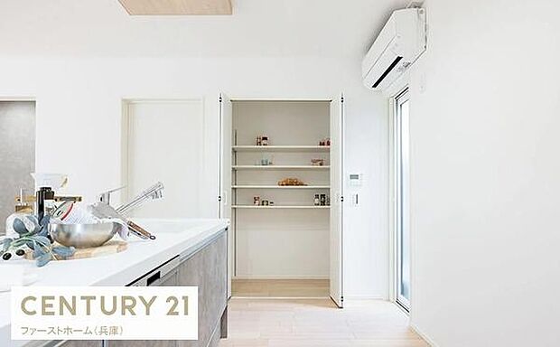 扉付きの収納スペースが室内に設けられています。シンプルなデザインで清潔感があります。整理整頓がしやすい棚構造です。隣には大きな窓があり明るさも感じられます。収納が充実した住まいです。