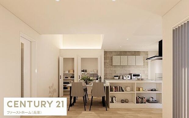 リビングがキッチンと一体感のある設計で開放的な雰囲気が広がります。シンプルな内装が空間をすっきりと見せています。収納棚も充実していて使い勝手も良好です。