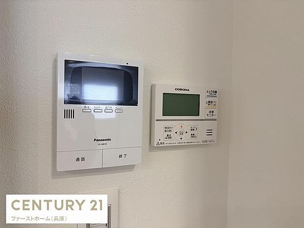 壁に設置されたモニター付きインターホンと給湯器リモコンが特徴的です。操作しやすい位置にあり機能面でも便利さを感じられます。シンプルなデザインで空間に馴染みます。見やすいパネル表示もポイントです。