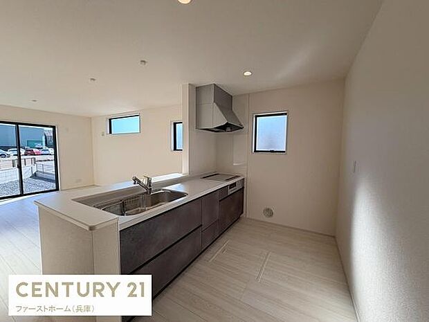 シンプルで洗練されたキッチン空間です。2面の窓から自然光が入るため日中も明るく開放的です。対面式なのでリビングと一体感のある設計です。たっぷりと収納スペースが確保されています。