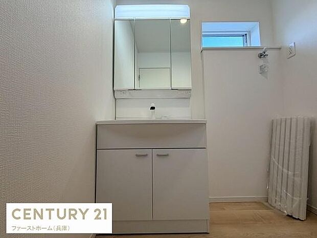 シンプルなデザインの洗面台が設置されています。上部のミラー収納で使い勝手も良好です。窓があるため明るい印象の洗面所となっています。清潔感のある空間を演出しています。広めのスペースで動線もスムーズです。