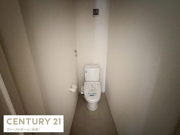 シンプルなデザインで清潔感のある空間です。手洗い一体型のトイレを備えています。独立した配置でゆったりと使用できます。換気設備も設置されています。