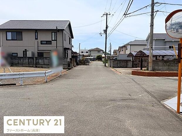 幅員の広い前面道路が魅力の現地写真です。角地に位置し通行もしやすい環境です。周辺住宅街の落ち着いた雰囲気が印象的です。歩道やガードレールもしっかり整備されています。