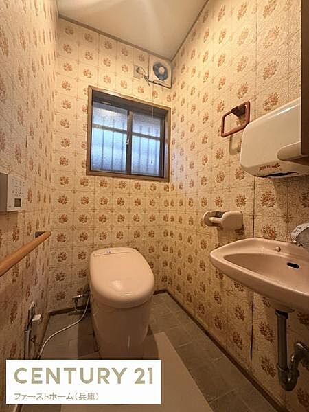窓があり明るさを感じられるトイレです。換気扇も設置されているので空気の循環がしやすいです。手洗い場がトイレスペース内にあり便利です。壁紙のデザインが特徴的で空間に個性を与えています。