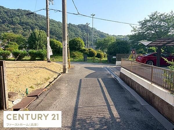 前面道路は舗装されており敷地へのアプローチがスムーズです。周囲には豊かな緑が広がり落ち着いた住環境が感じられます。車の出入りもゆとりをもって行えます。電柱やフェンスも整備されています。