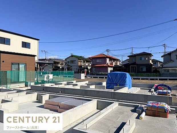 晴れた空の下現地の様子がしっかりと確認できます。周囲の住宅街の雰囲気も分かり落ち着いた環境です。前面道路も見通しが良く開放感があります。基礎工事の進行状況が分かる一枚です。