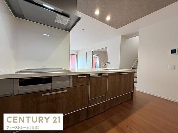 木目調のキッチンが落ち着いた印象を演出しています。IHコンロ付きでお手入れも簡単です。カウンターキッチン仕様で開放感があります。収納スペースも充実しています。