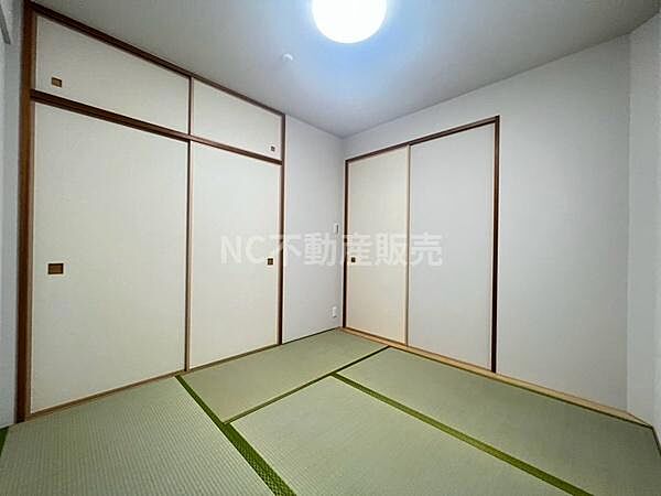 和室のシンプルなデザインが特徴です。畳の目が整い清潔感のある空間となっています。ふすまや天井も落ち着いた色合いでまとまっています。収納スペースも確保されています。照明も明るさが十分です。