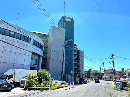 シンプルな外観が特徴の中層マンションです。周辺道路も広々としており車の出入りもスムーズです。日当たりのよい立地で快適にお過ごしいただけます。青空の下建物の存在感が際立っています。