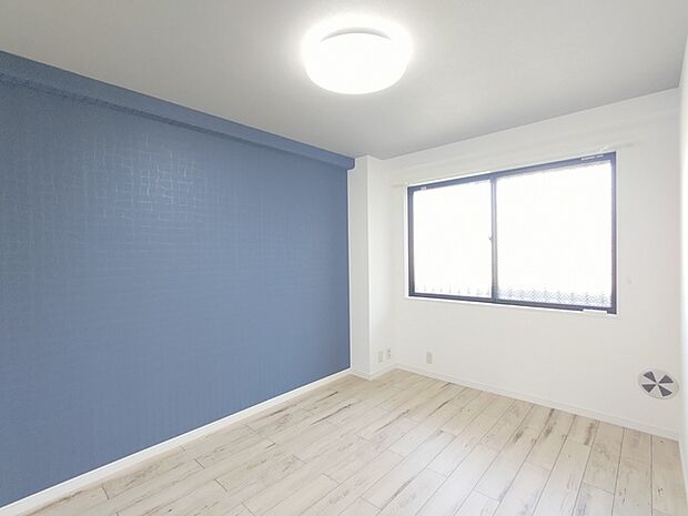 紺色のアクセントクロスがかっこいいお部屋。（洋室 約6.2帖）