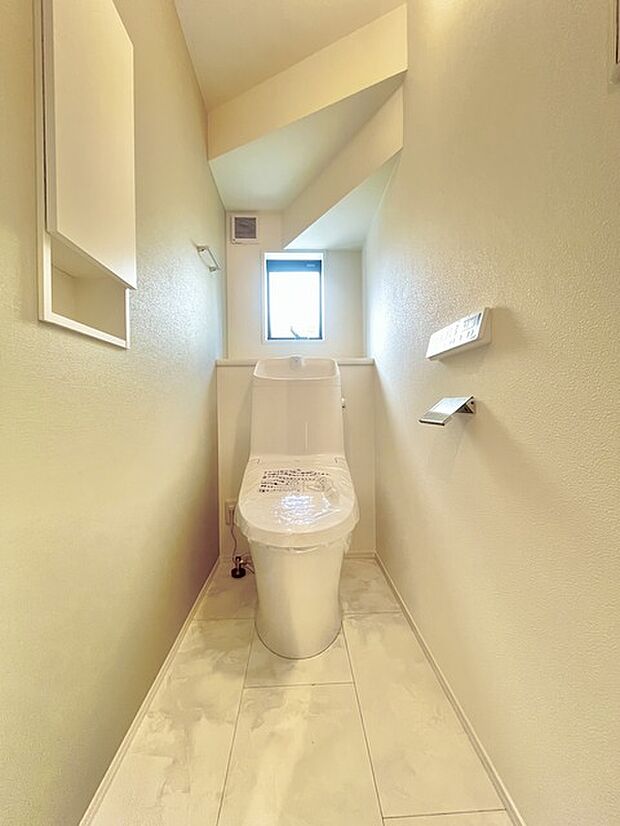 ウォシュレット機能付きのトイレ。換気のしやすい窓付きで、収納もあり実用性も兼ね備えた造り。