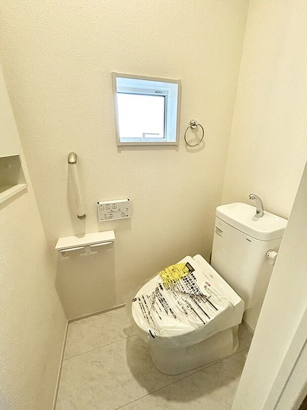 ウォシュレット機能付きのトイレ。換気のしやすい窓付きで、収納もあり実用性も兼ね備えた造り。