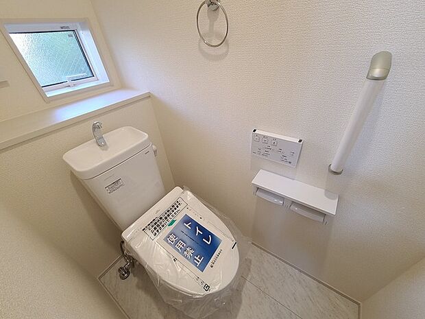 ウォシュレット機能付きのトイレ。換気のしやすい窓付きで、収納もあり実用性も兼ね備えた造り。