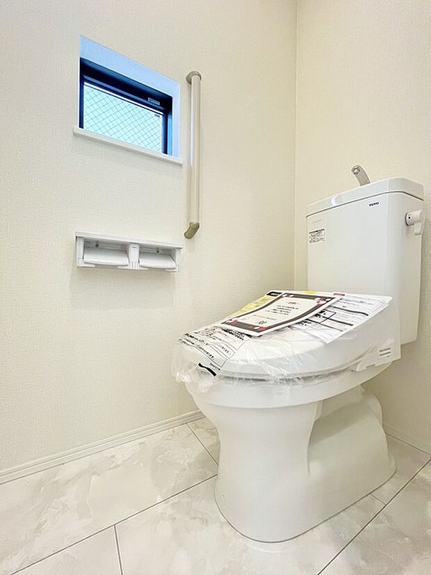 ウォシュレット機能付きのトイレ。換気のしやすい窓付きで、収納もあり実用性も兼ね備えた造り。 
