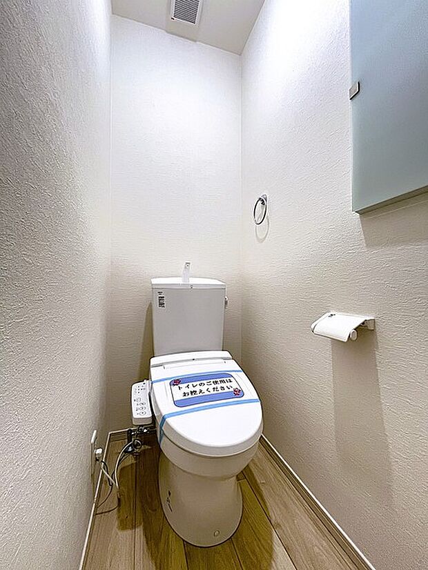 ウォシュレット機能付きのトイレ。収納もあり実用性も兼ね備えた造り。