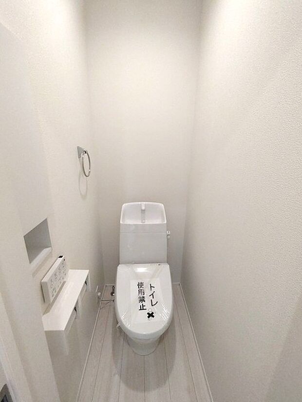 ウォシュレット機能付きのトイレ。収納もあり実用性も兼ね備えた造り。