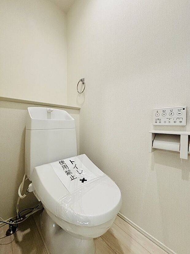 ウォシュレット機能付きのトイレ。収納もあり実用性も兼ね備えた造り。