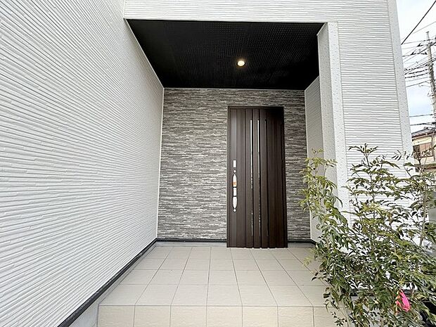 アプローチからの玄関がおしゃれな住宅。出発も帰宅も楽しみになるかも。