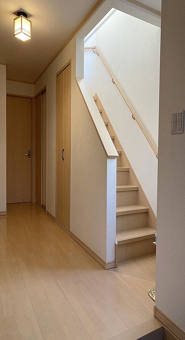 2階へと繋がる階段には、手すりが設置されています。窓から自然光が差し込みます。