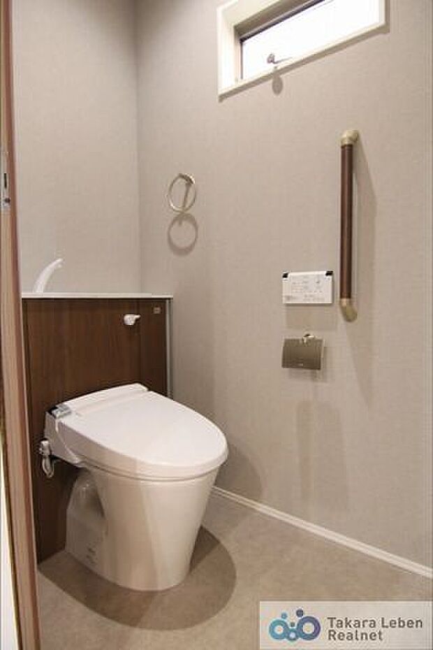 1階トイレのシックな色調と違い、2階トイレは暖かみのある空間。どちらも手すり付きです。