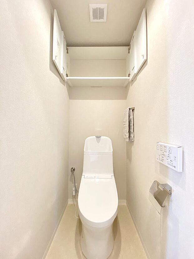 【トイレ】新調された清潔感あるトイレ空間です。手洗い・温水洗浄便座つきトイレで、座った時にヒヤっとせず快適なトイレ時間を過ごせます。上部には扉付きの収納がついていて、お掃除グッズなどをしまえます。
