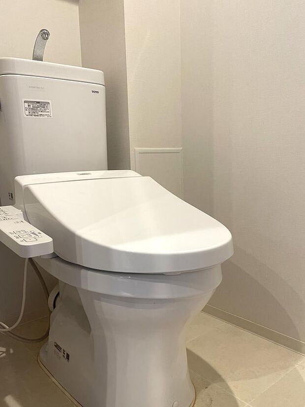 トイレの温水洗浄便座新調済。壁には吊り戸棚が付いていて、トイレ用品を収納することができます。